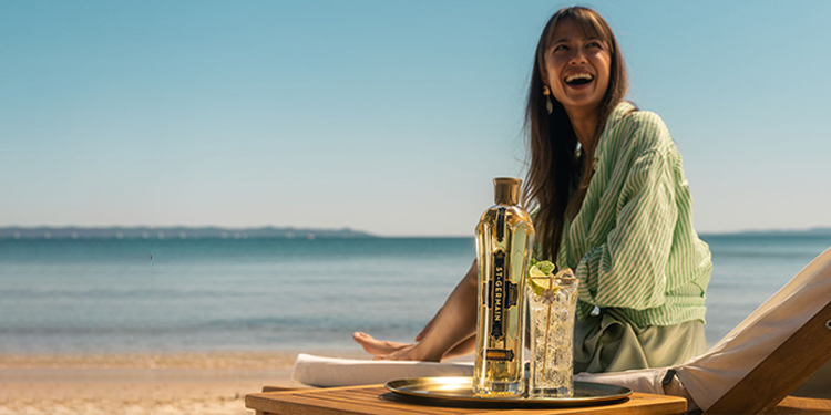 lady enjoying st germain on a beach